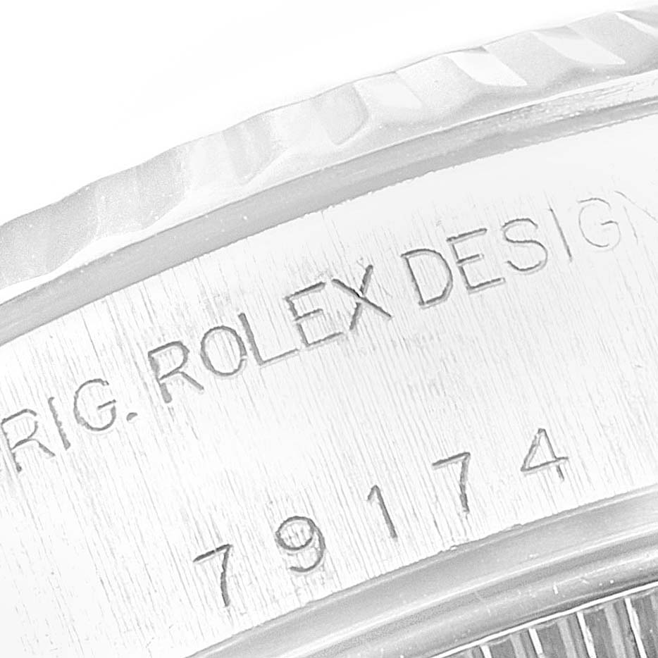 This close-up angle shows the engraved serial number and part of the bezel of the Rolex Datejust 79174 Women
s Stainless Steel Black Dial 79174 Women
s Stainless Steel Black Dial watch.