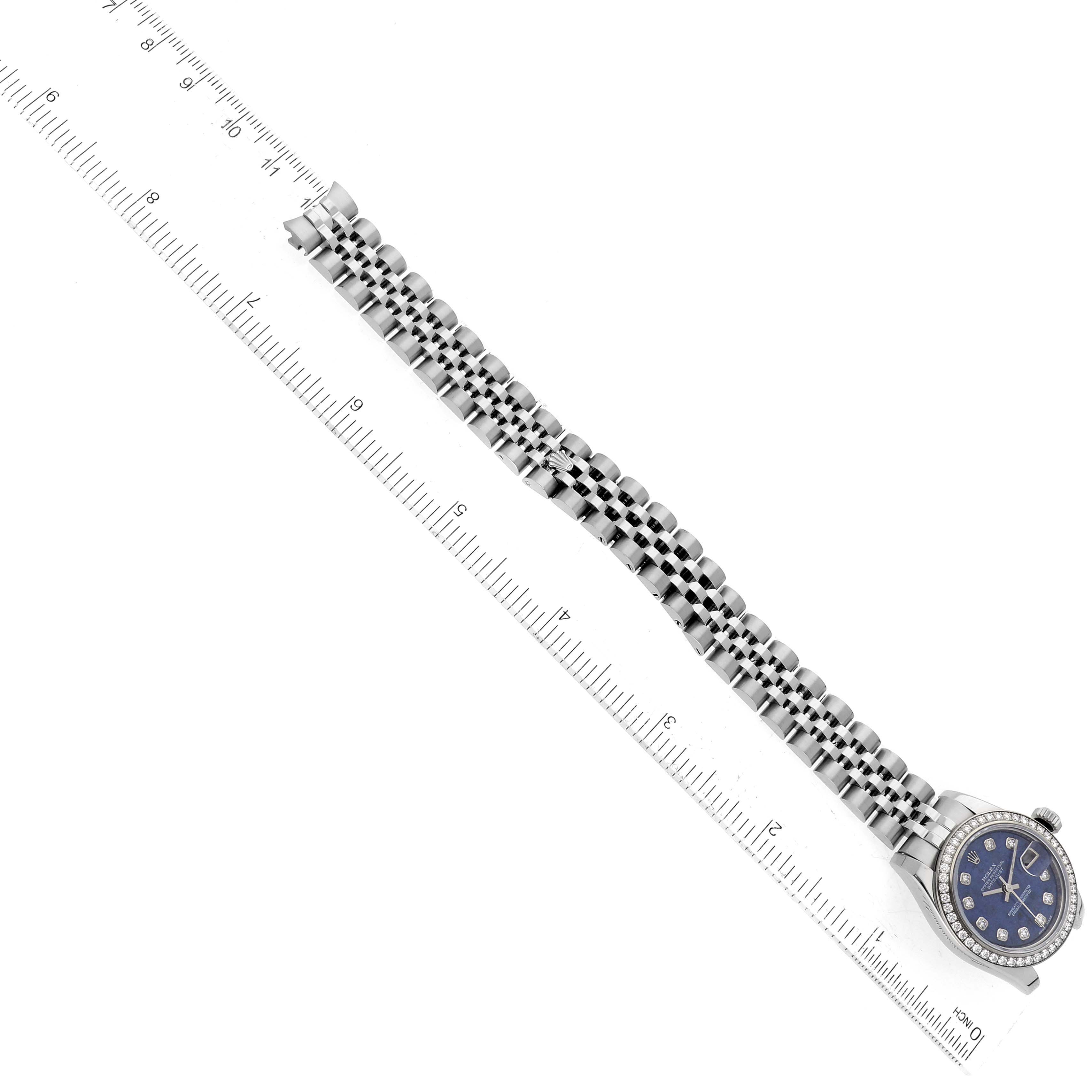 The image shows a Rolex Datejust 179384 Women's Stainless Steel Blue Dial 179384 Women's Stainless Steel Blue Dial watch at an overhead angle, highlighting the full bracelet and part of the dial next to a ruler.