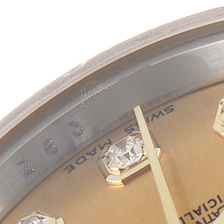 The image shows a close-up of the dial and part of the bezel of a Rolex Datejust 179173 Women's Steel and Gold (two tone) Champagne Dial 179173 Women's Steel and Gold (two tone) Champagne Dial watch.