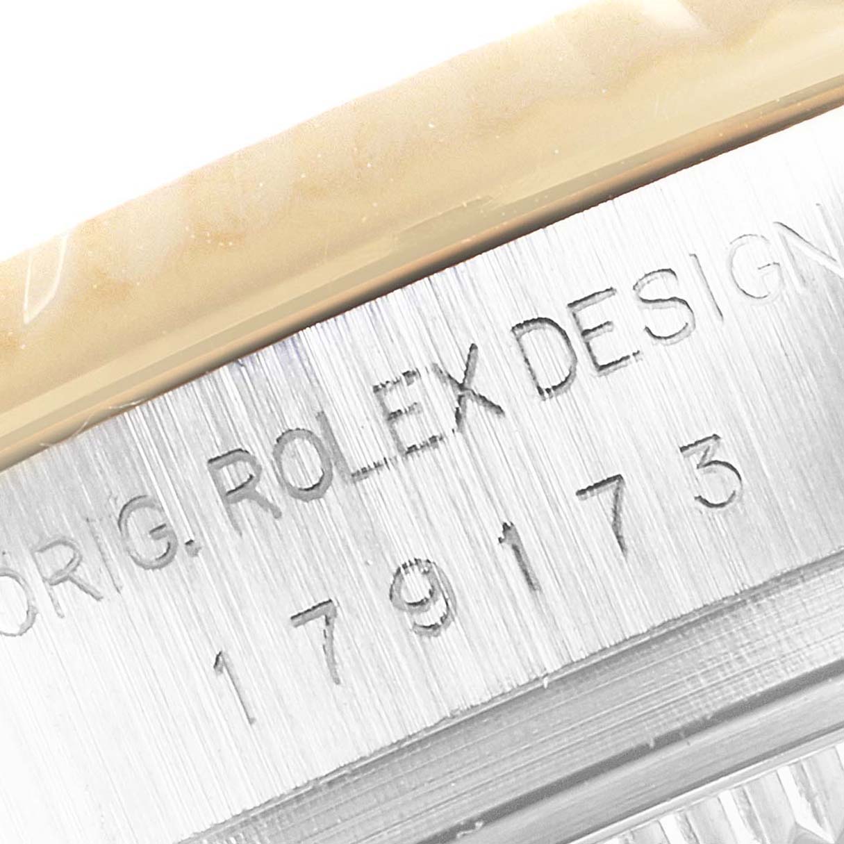 This close-up image shows part of the case and engraved details of a Rolex Datejust 179173 Women's Steel and Gold (two tone) Champagne Dial 179173 Women's Steel and Gold (two tone) Champagne Dial watch.