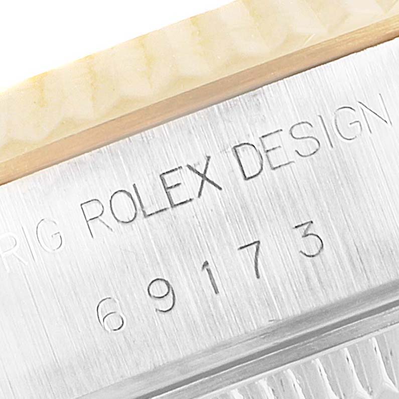 The image shows a close-up of the engraved model number and the fluted bezel of a Rolex Datejust 69173 Women's Steel and Gold (two tone) Champagne Dial 69173 Women's Steel and Gold (two tone) Champagne Dial watch.