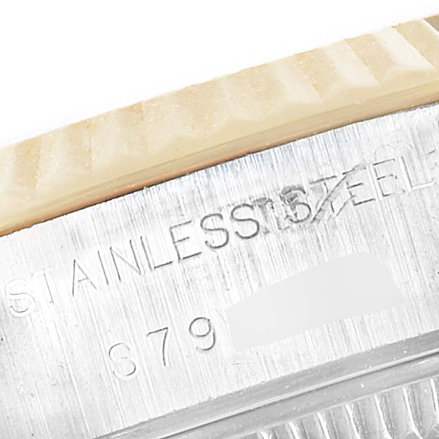 This close-up image shows the engraved text on the side of the stainless steel case of a Rolex Datejust 69173 Women's Steel and Gold (two tone) Champagne Dial 69173 Women's Steel and Gold (two tone) Champagne Dial watch.