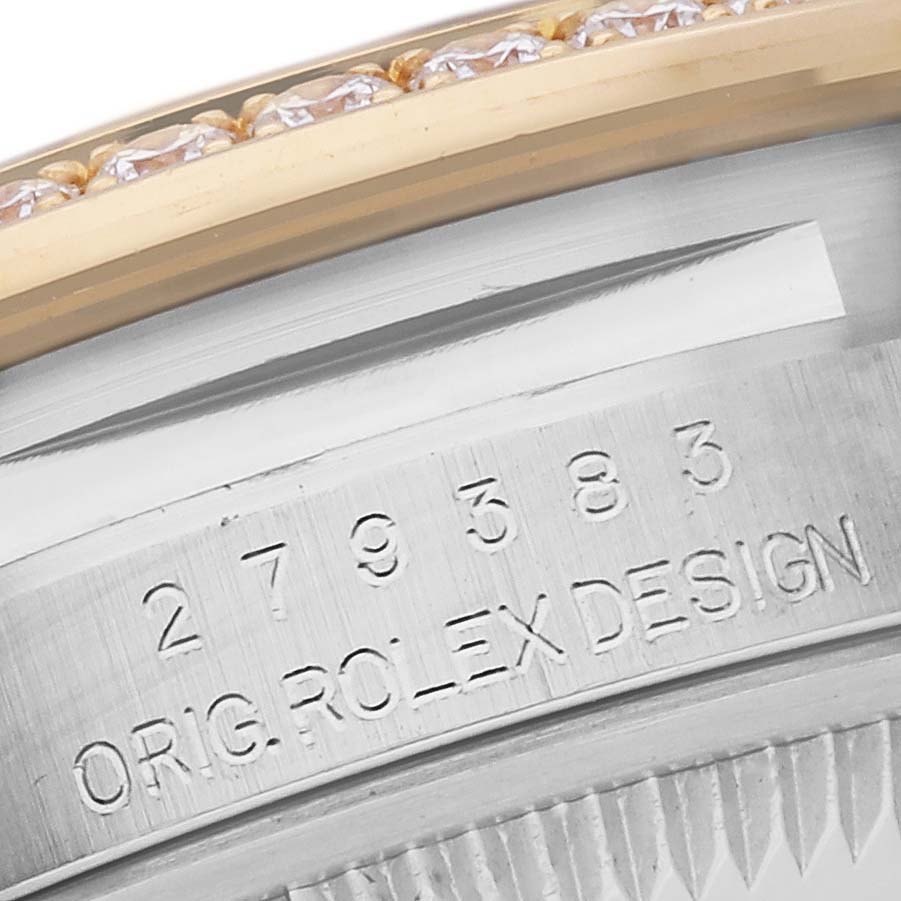 This image shows the serial number and "Orig. Rolex Design" engraving on the side of a Rolex Datejust 279383 Women's Steel and Gold (two tone) Green Dial 279383 Women's Steel and Gold (two tone) Green Dial model, near the gemstone bezel.