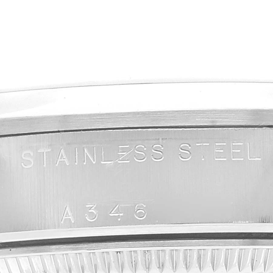 This image shows a close-up of the stainless steel case back edge of a Mid-Size Rolex watch.