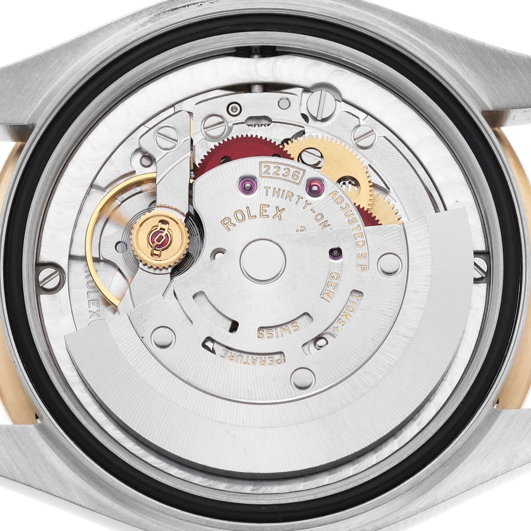 This image shows the movement of a Rolex Datejust 278343 Women's Steel and Gold (two tone) Grey Dial, highlighting gears and inscriptions.