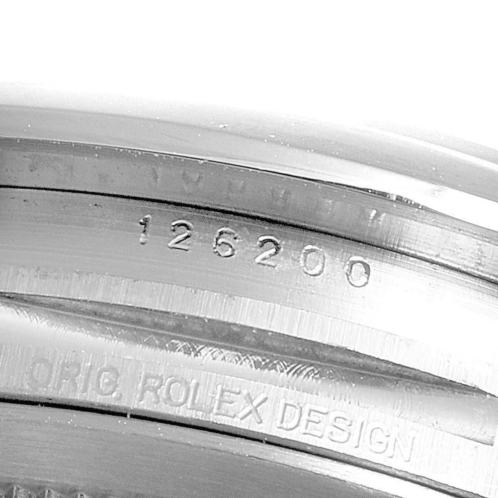 This image shows a close-up of the engraved case details of the Rolex Datejust 126200 Men's Stainless Steel Black Dial 126200 Men's Stainless Steel Black Dial model, including the model number "126200."