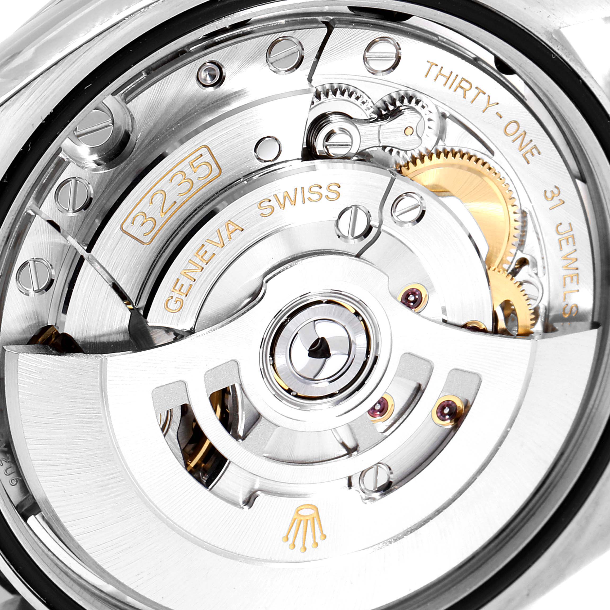 This image shows a close-up of the movement mechanism inside the Rolex Datejust 126200 Men's Stainless Steel Black Dial 126200 Men's Stainless Steel Black Dial watch, highlighting the intricate gears and jewels.