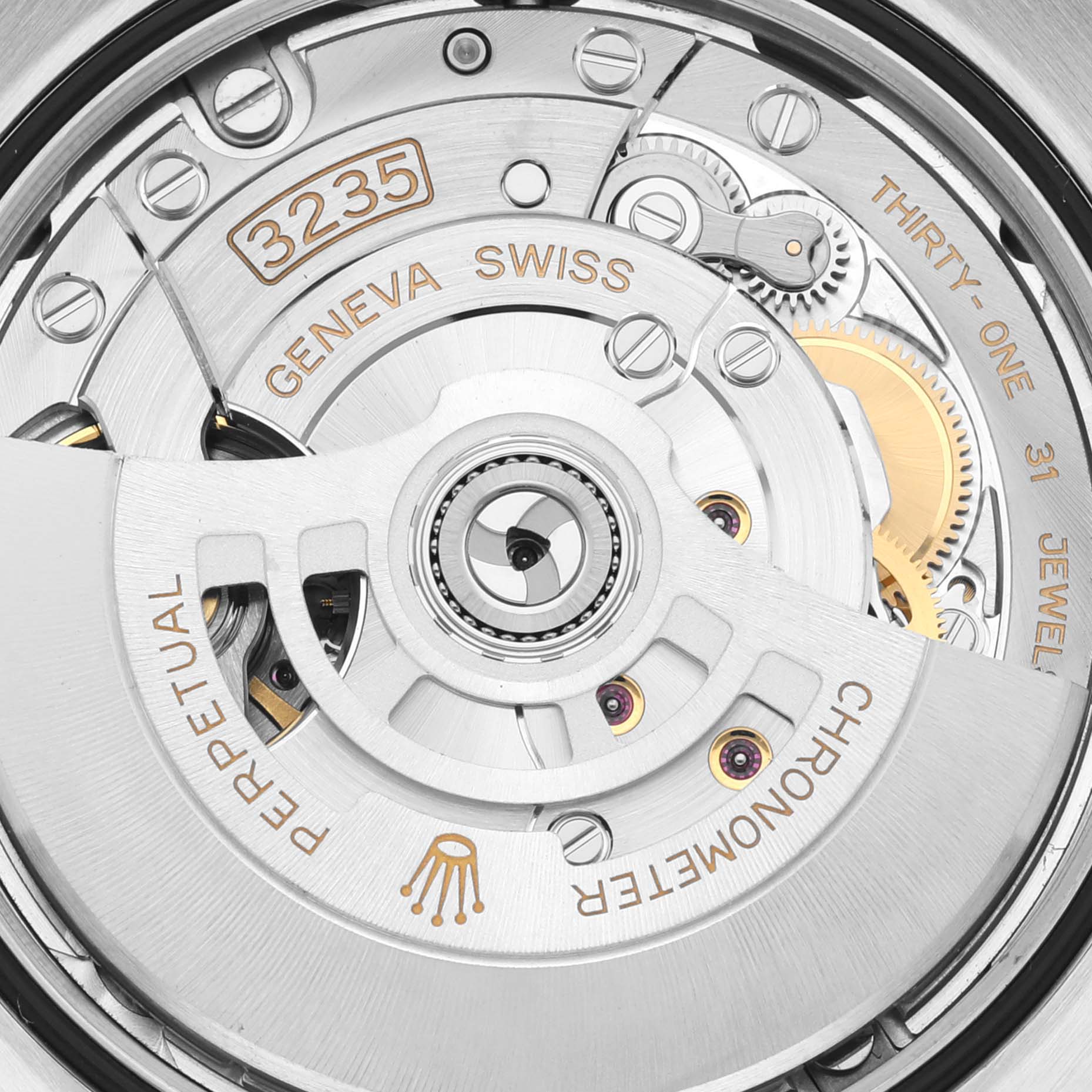 This image shows a close-up view of the Rolex Datejust 126201 Men's Steel and Gold (two tone) Grey Dial 126201 Men's Steel and Gold (two tone) Grey Dial model's movement, specifically the automatic mechanism with engravings.