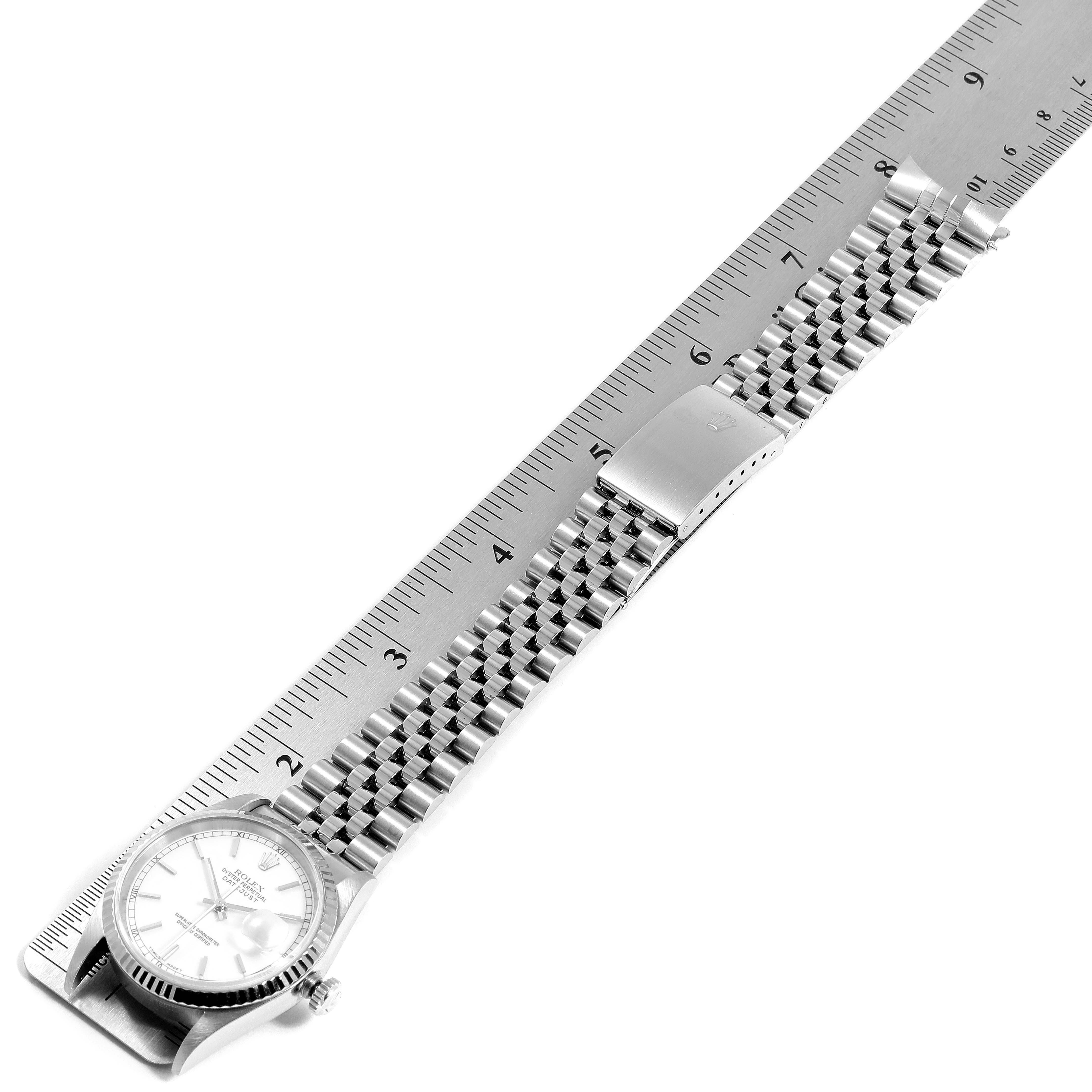 The image shows a Rolex Datejust 16234 Men's Stainless Steel White Dial 16234 Men's Stainless Steel White Dial watch laid flat next to a ruler, highlighting its bracelet and clasp.