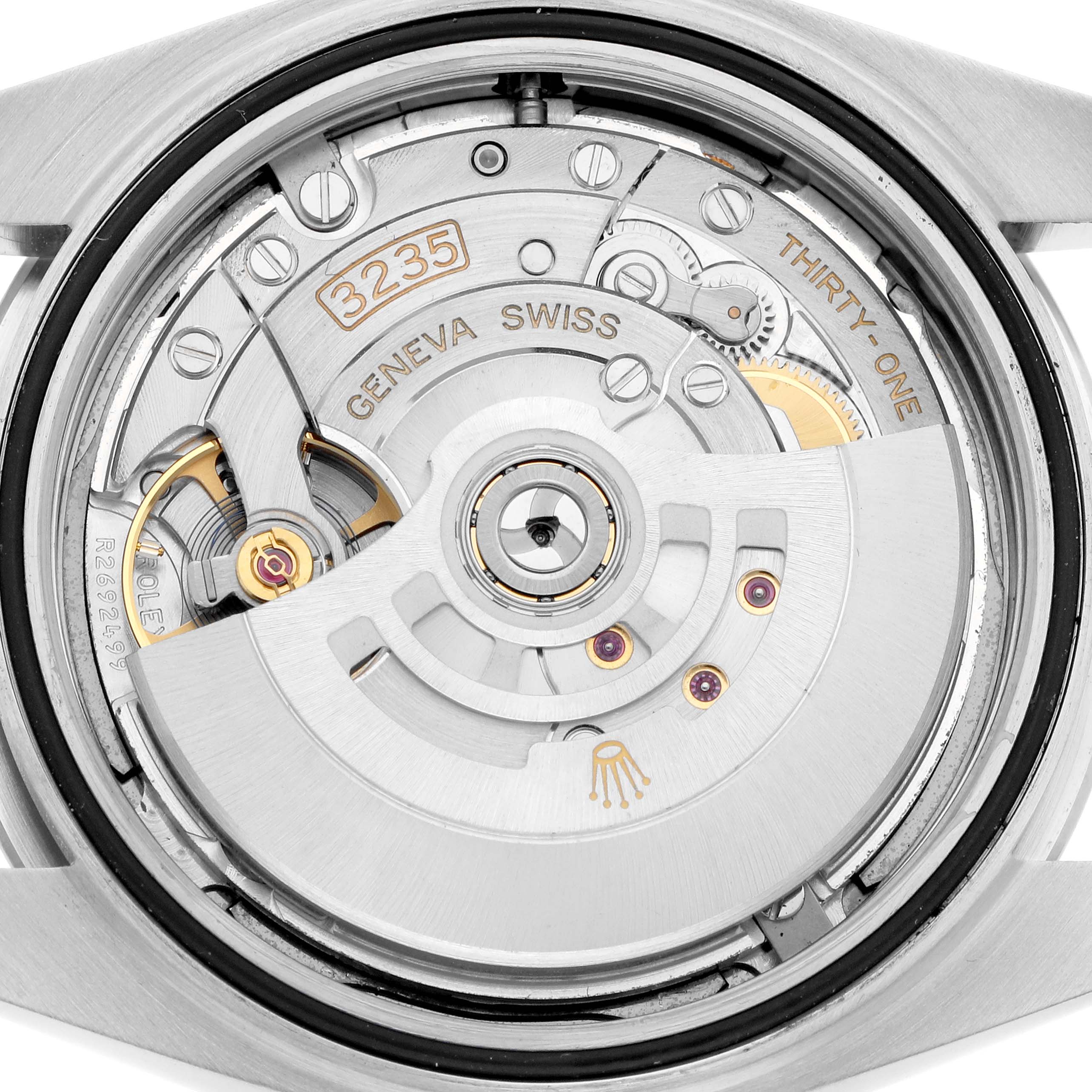The image shows the Rolex Datejust 126300 Men
s Stainless Steel Grey Dial
s movement from the back, highlighting the rotor, gears, and intricate components.