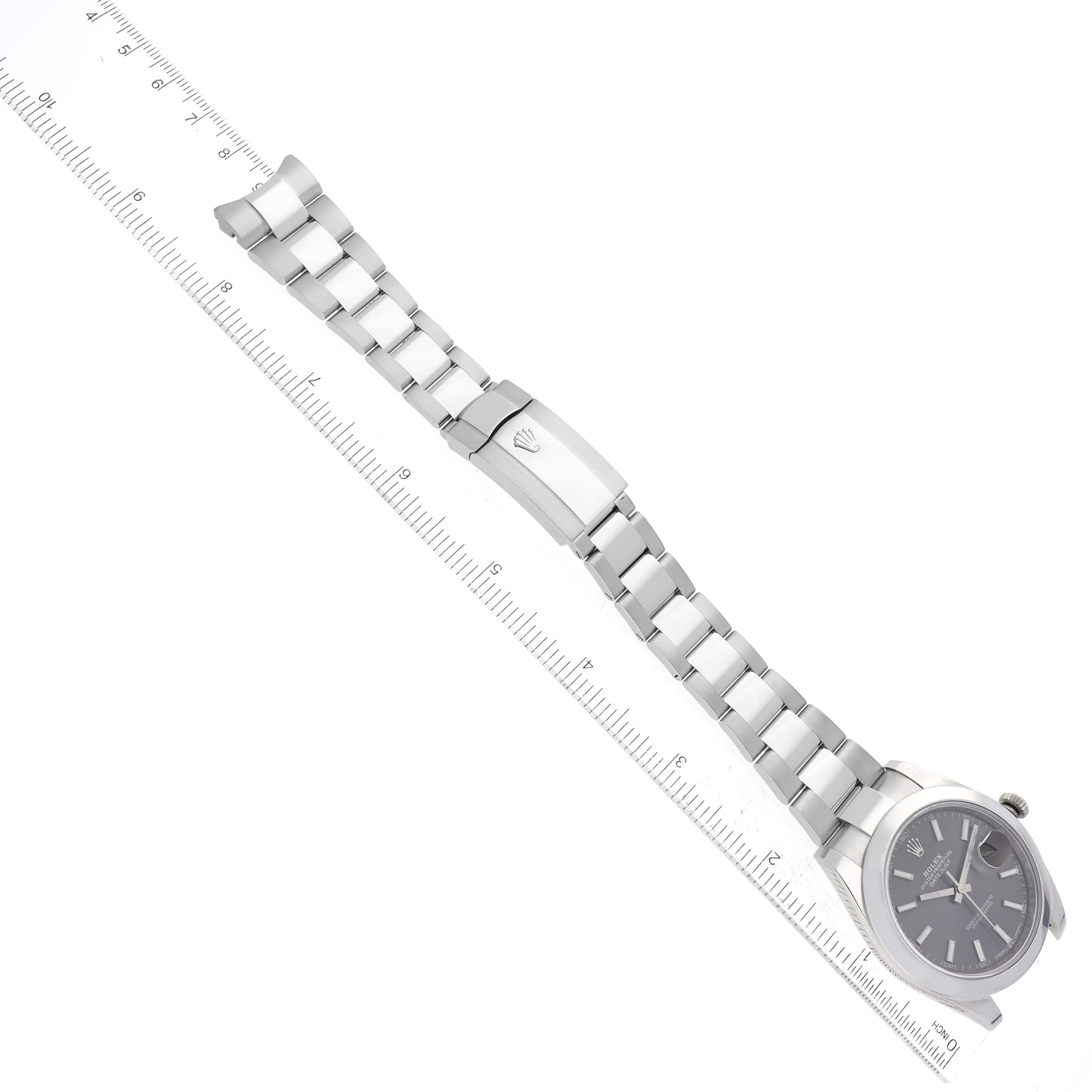 The image shows a Rolex Datejust 41 126300 Men's Stainless Steel Grey Dial 126300 Men's Stainless Steel Grey Dial watch laid flat with a metal bracelet and a visible clasp next to a ruler for scale.