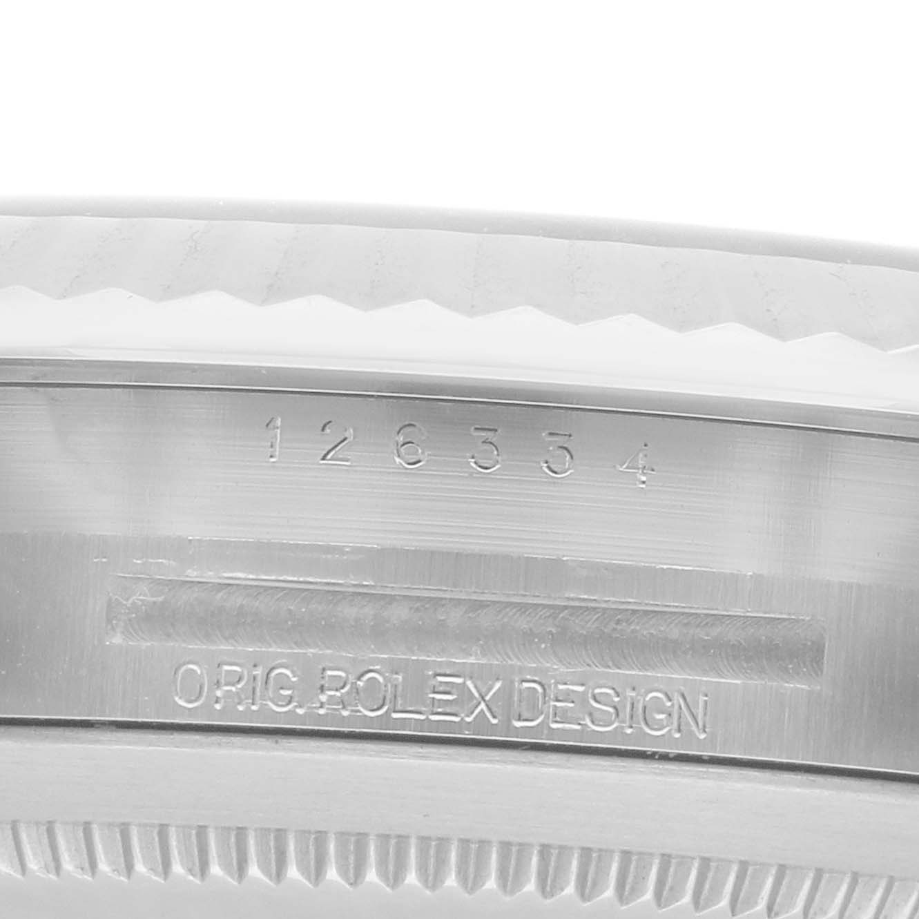 The image shows a close-up of the engraved bezel and inner rim of a Rolex Datejust 41 126334 Men
s Stainless Steel Blue Dial watch.