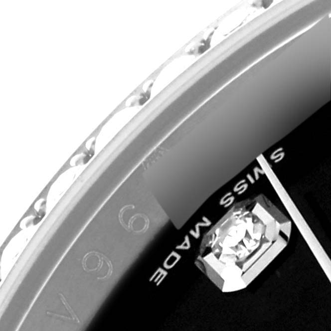 Close-up of the Rolex Datejust 116244 Men's Stainless Steel Black Dial 116244 Men's Stainless Steel Black Dial showing the bezel edge, part of the dial, and "Swiss Made" text.