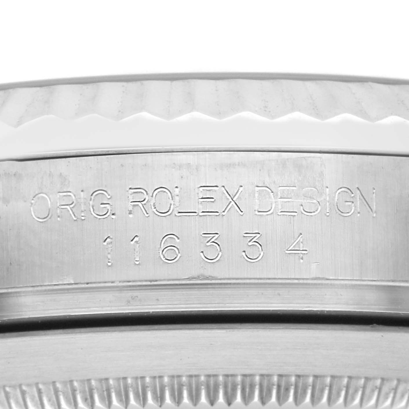 The image shows a close-up of the side of the Rolex Datejust 41 116334 Men
s Stainless Steel Silver Dial, focusing on the engraved text and a portion of the bezel.
