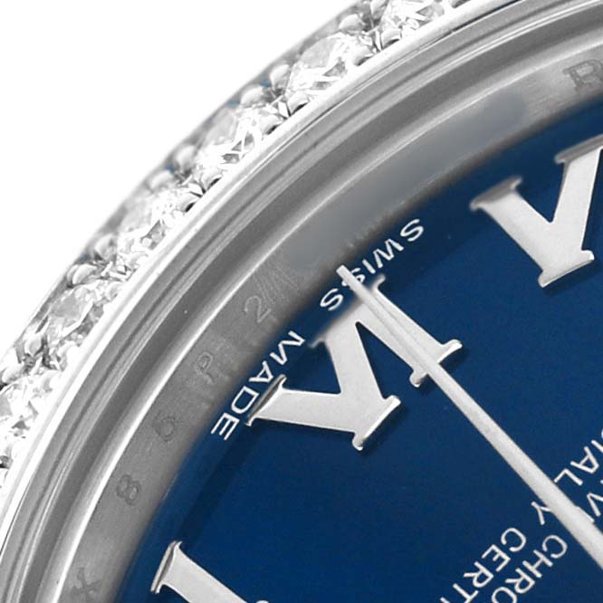 This close-up of the Rolex Datejust 178384 Women's Stainless Steel Blue Dial shows part of the dial, minute hand, and a diamond-encrusted bezel at an oblique angle.