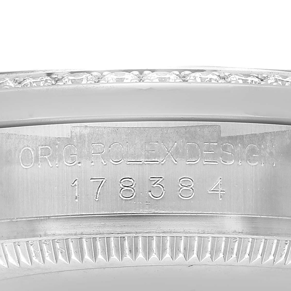 The image shows a close-up of the engraved case side of a Rolex Datejust 178384 Women's Stainless Steel Blue Dial watch, displaying the model number.