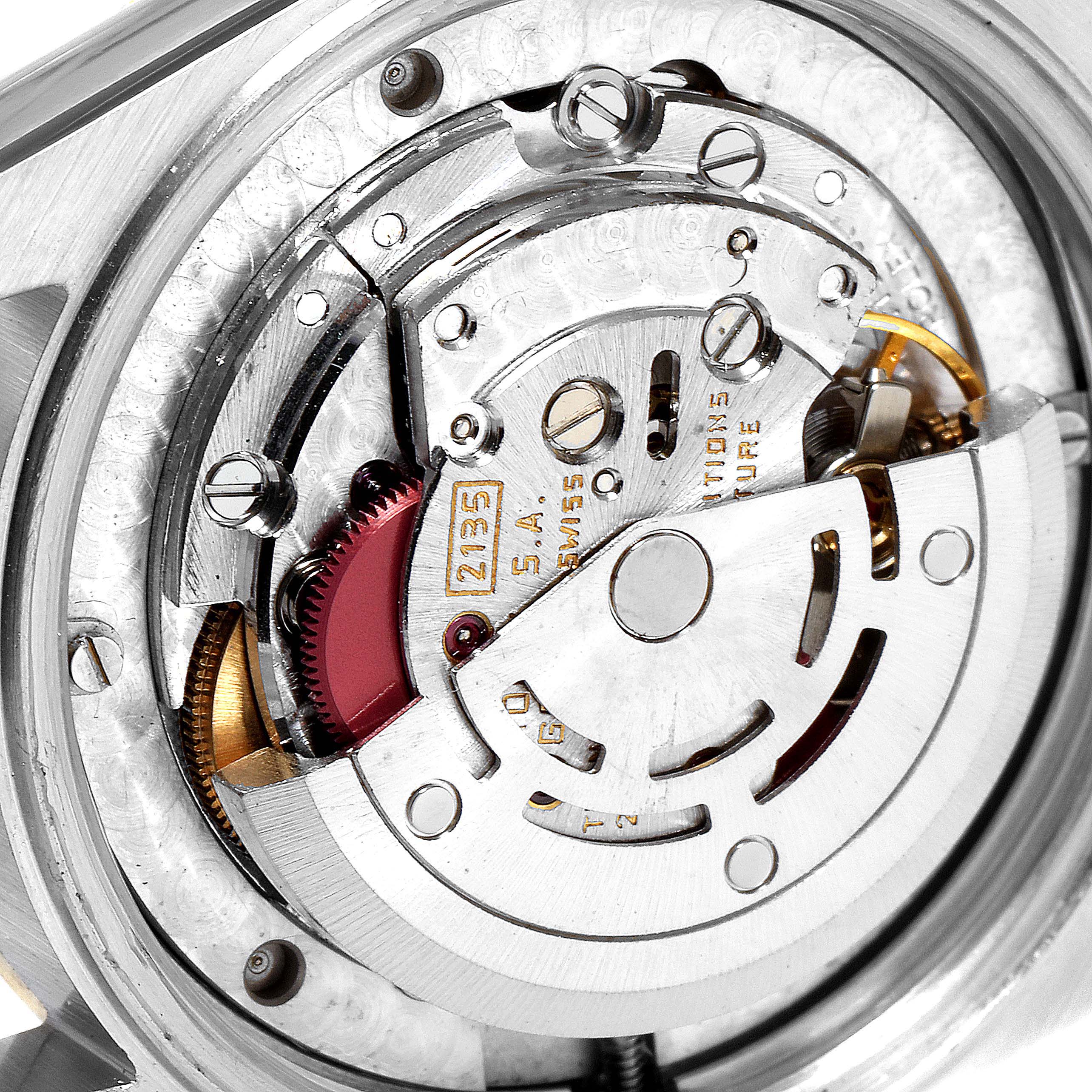 The image shows the internal mechanism of a Rolex Mid-Size 68273 Women
s Steel and Gold (two tone) Black Dial 68273 Women
s Steel and Gold (two tone) Black Dial model watch at a close-up angle, highlighting the rotor and gears.