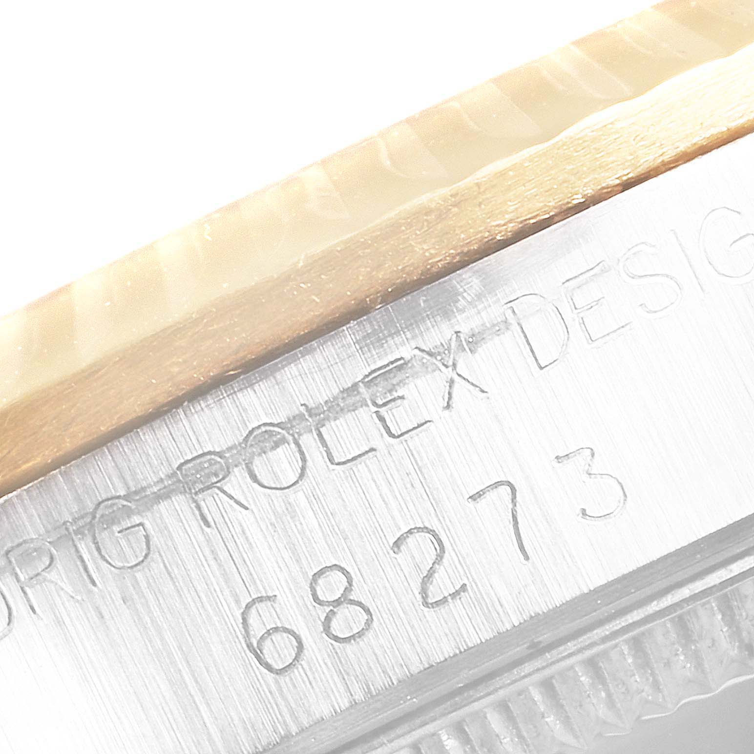 This close-up image shows the side of a Mid-Size Rolex watch case, highlighting the engraved model number 68273.