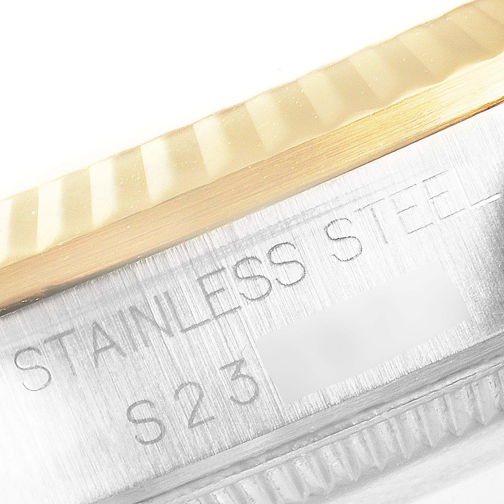 This is a close-up angle of the case and bezel of a Mid-Size Rolex watch, showing "STAINLESS STEEL" engraving.