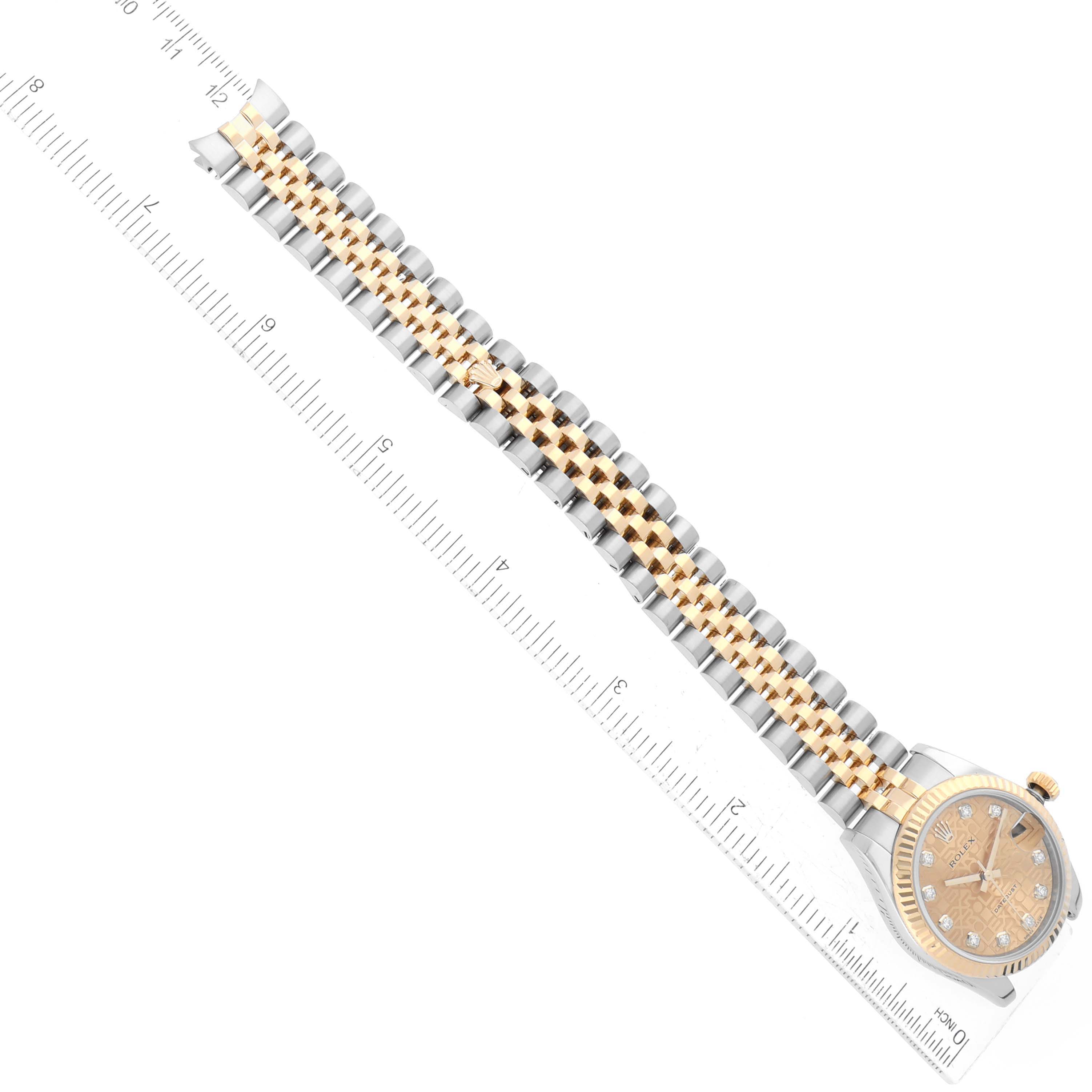 This image shows a top-down view of a Mid-Size Rolex watch with a gold and silver jubilee bracelet placed against a ruler.