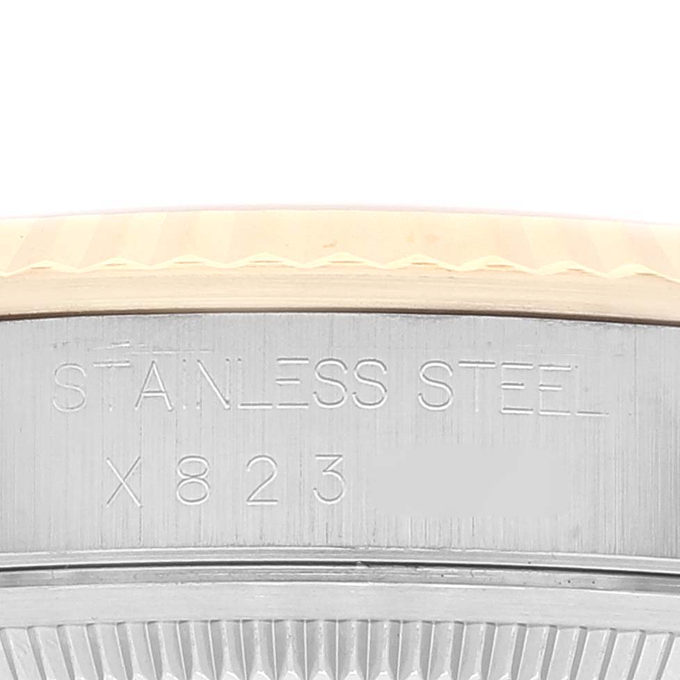 This image shows a close-up of the side case and the fluted bezel of a Rolex Datejust 16233 Men's Steel and Gold (two tone) White Dial 16233 Men's Steel and Gold (two tone) White Dial watch, highlighting the stainless steel material.