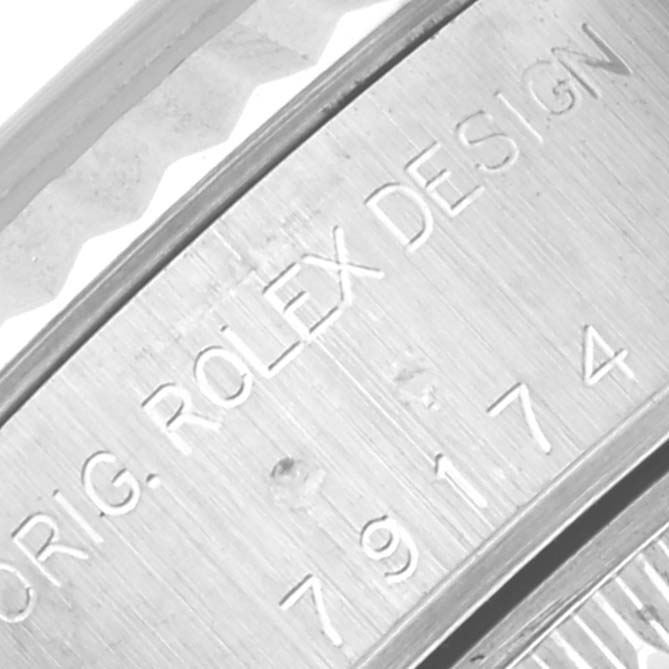 This close-up image shows the engraved details and fluted bezel edge of a Rolex Datejust 79174 Women's Stainless Steel Mother of Pearl Dial 79174 Women's Stainless Steel Mother of Pearl Dial watch.