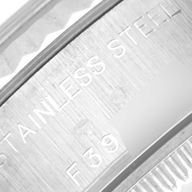 The image shows a close-up of the engraving on the side of a Rolex Datejust 79174 Women's Stainless Steel Mother of Pearl Dial 79174 Women's Stainless Steel Mother of Pearl Dial watch, indicating "STAINLESS STEEL."