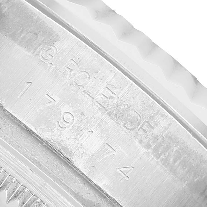 The image shows a close-up of the serial number and branding engraved on the side of a Rolex Datejust 179174 Women's Stainless Steel Silver Dial watch bezel.