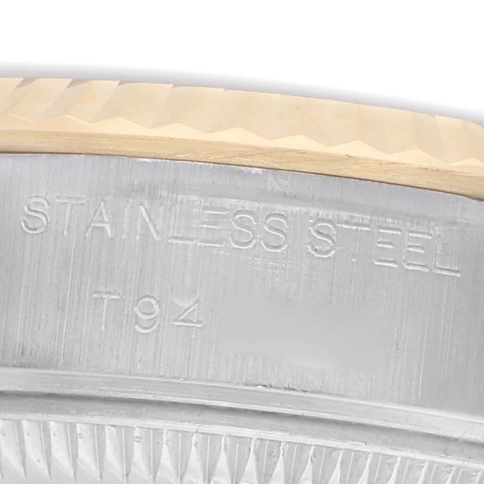 The image shows a detailed close-up of the edge of the caseback and fluted bezel of a Rolex Datejust 69173 Women's Steel and Gold (two tone) Champagne Dial watch.
