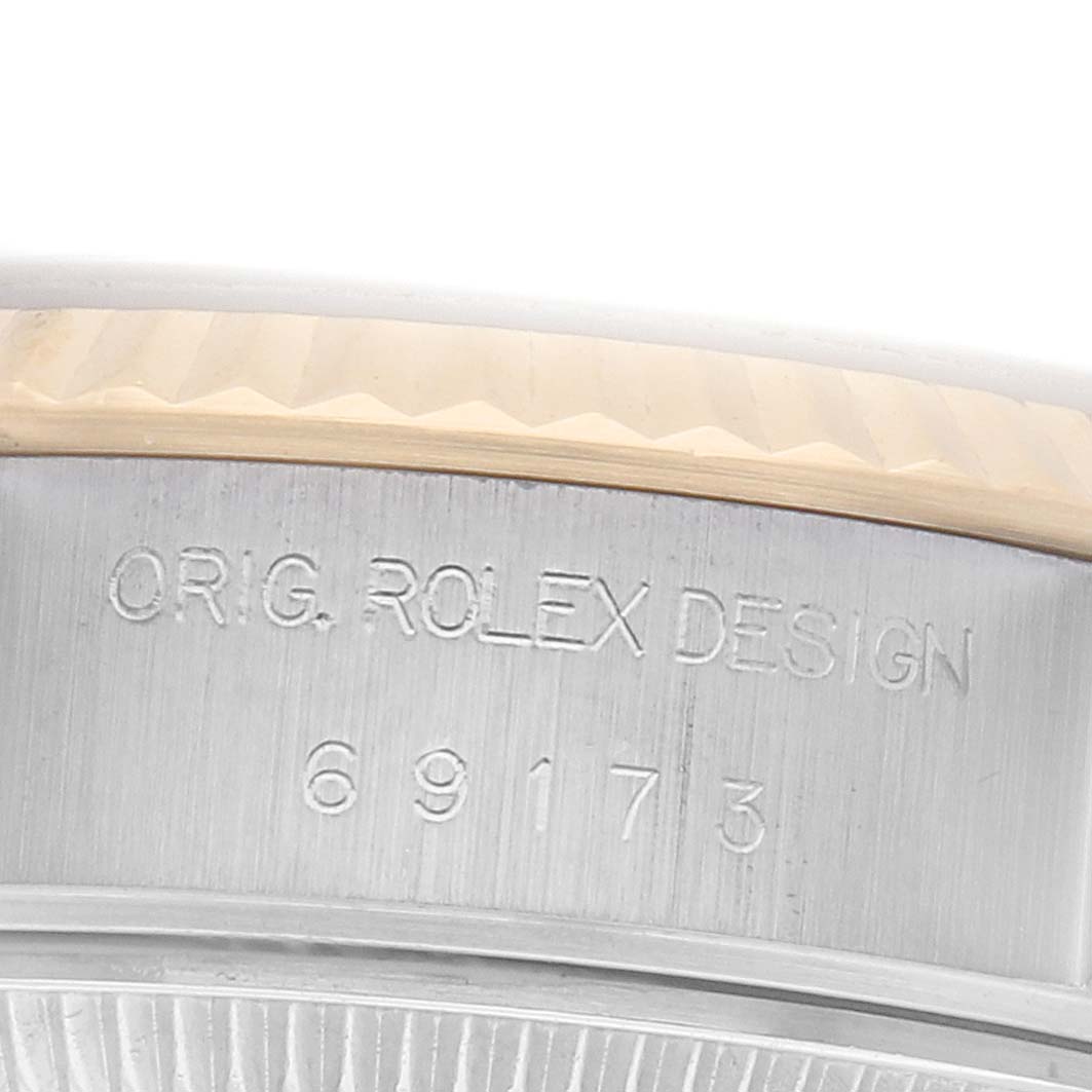 The image shows a close-up of the side of a Rolex Datejust 69173 Women's Steel and Gold (two tone) Silver Dial watch, displaying the case with the text "ORIG. ROLEX DESIGN" and a reference number.