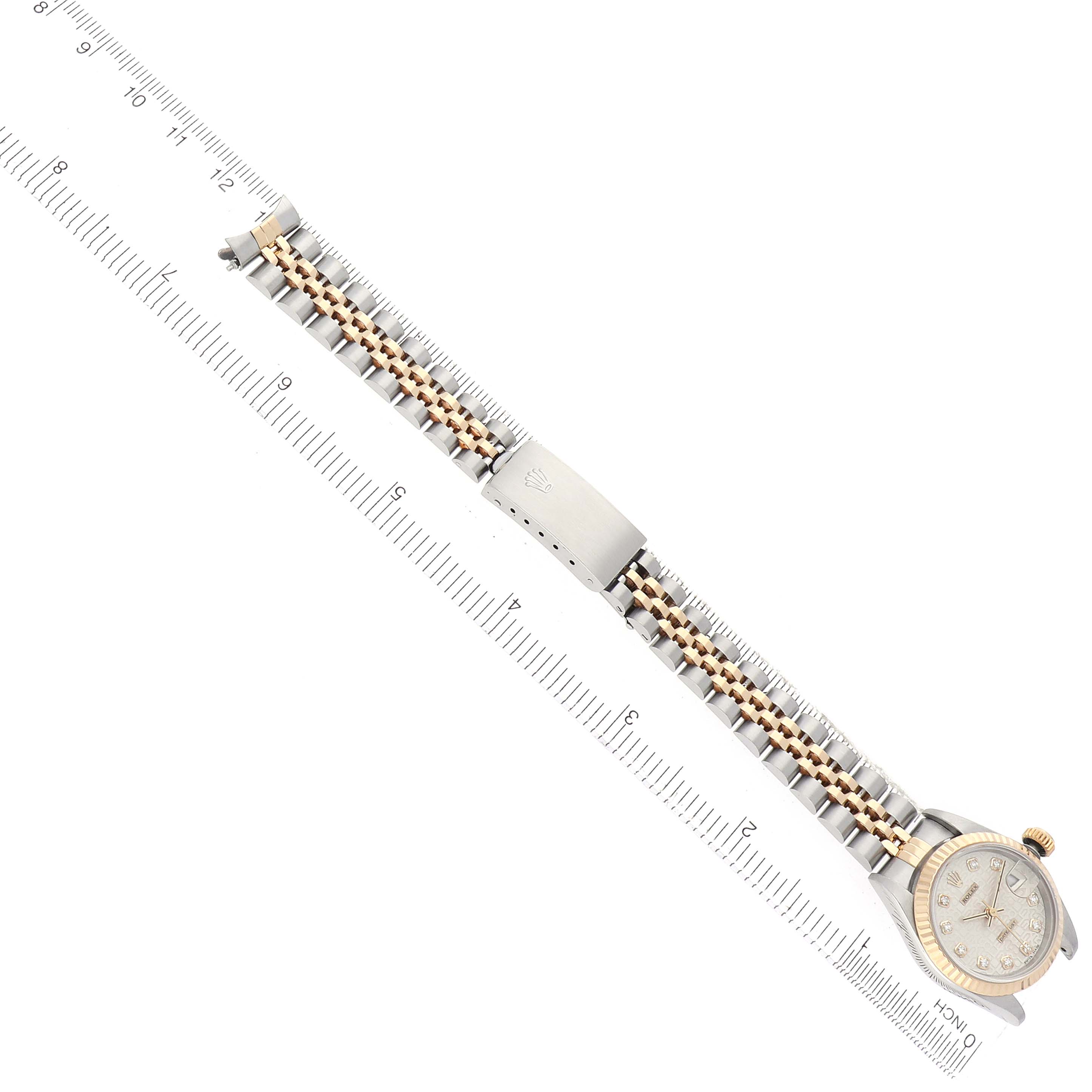 The image shows a Rolex Datejust 69173 Women's Steel and Gold (two tone) Silver Dial watch laid flat, highlighting its two-tone bracelet and clasp, positioned alongside a ruler.