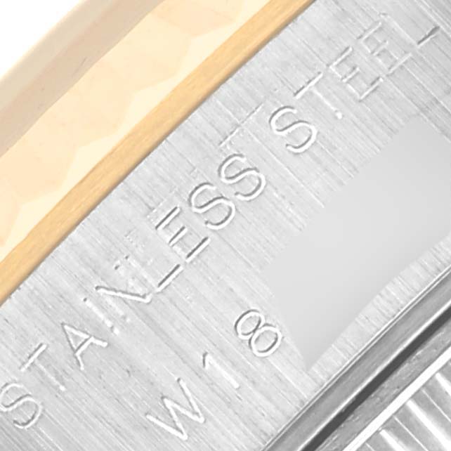 The image shows an extreme close-up of the case side of a Rolex Datejust 69173 Women's Steel and Gold (two tone) Black Dial 69173 Women's Steel and Gold (two tone) Black Dial watch, highlighting the engraved text.