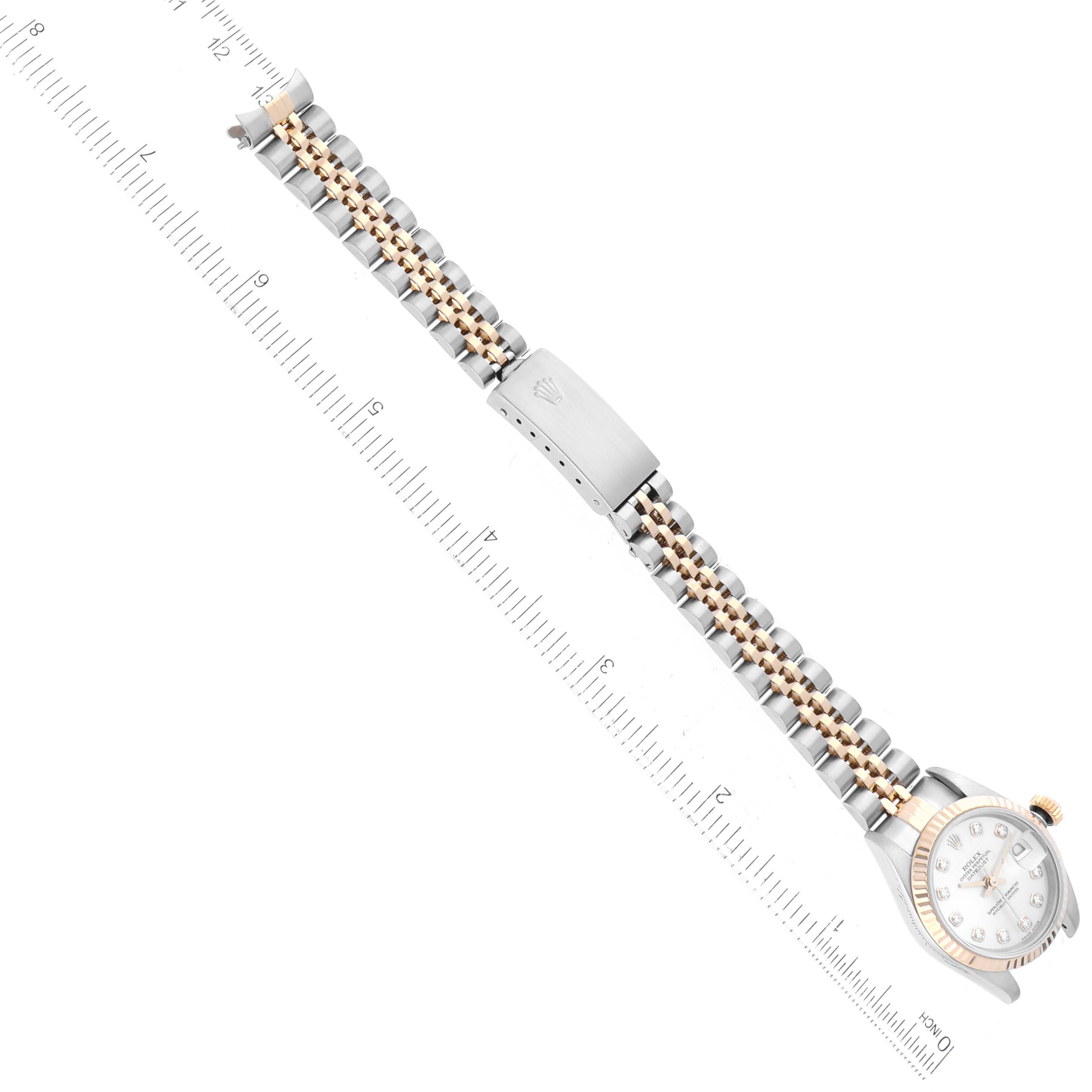 The image shows a Rolex Datejust 79173 Women's Steel and Gold (two tone) Silver Dial 79173 Women's Steel and Gold (two tone) Silver Dial watch from a top-down angle, highlighting the face, bracelet, and clasp, along with a ruler for scale.