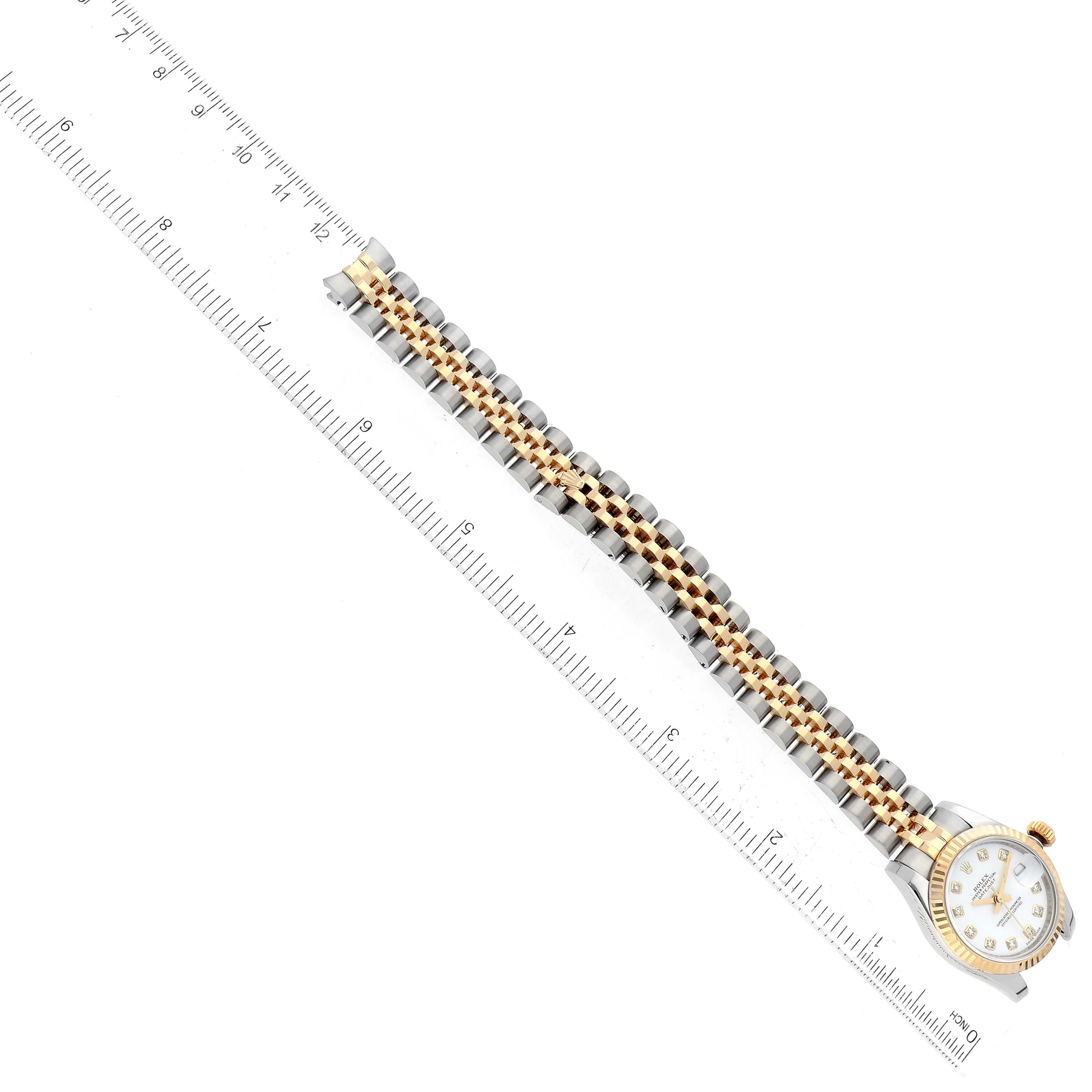 The image shows a Rolex Datejust 179173 Women's Steel and Gold (two tone) White Dial 179173 Women's Steel and Gold (two tone) White Dial watch from an overhead angle, featuring its gold and silver bracelet and watch face.