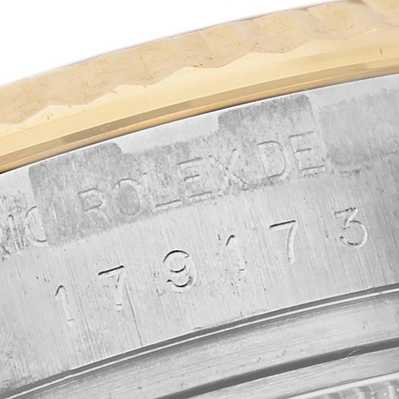 This image shows an extreme close-up of the reference number engraving on the case side of a Rolex Datejust 179173 Women's Steel and Gold (two tone) White Dial 179173 Women's Steel and Gold (two tone) White Dial watch.