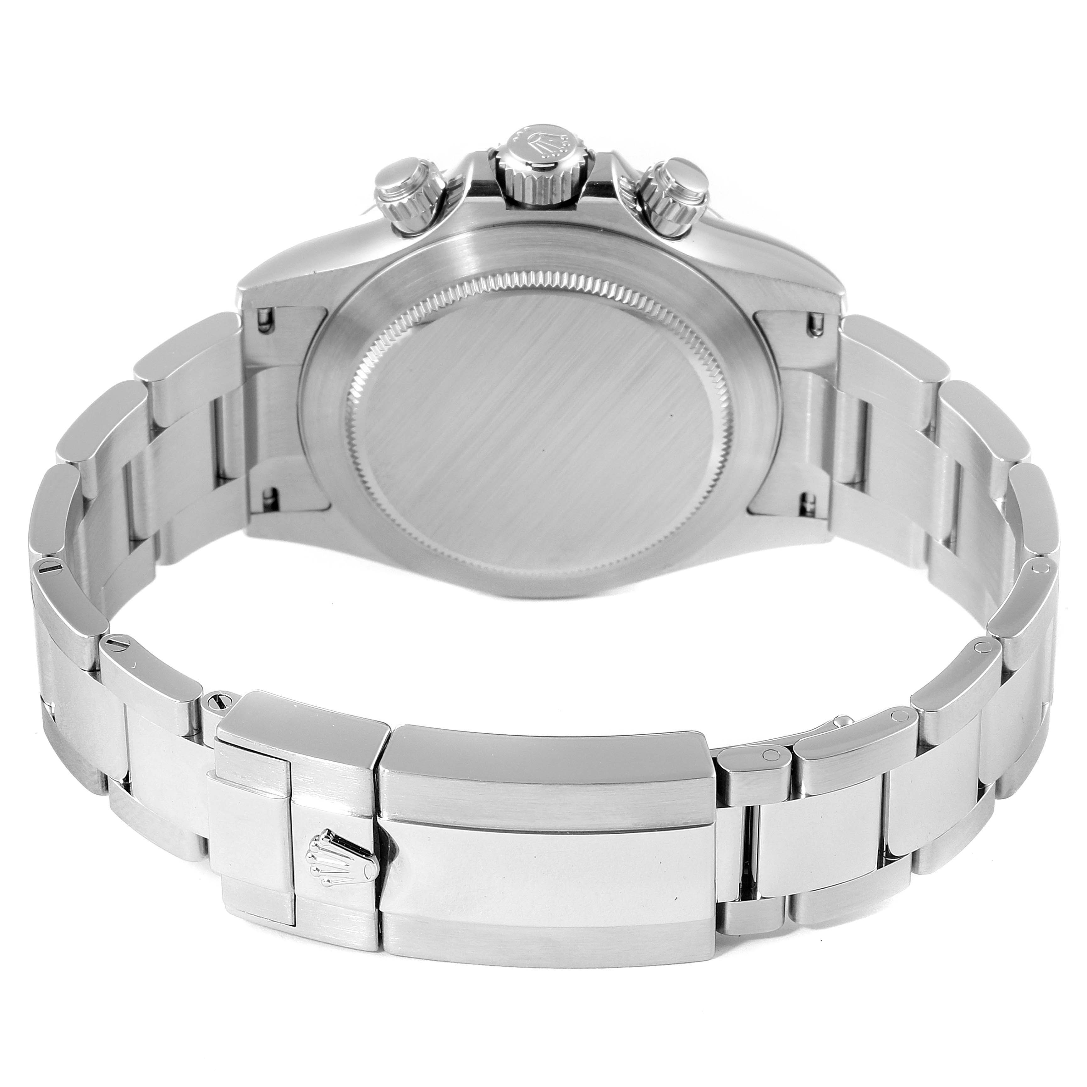 The image shows the back side of a Rolex Daytona 116520 Men
s Stainless Steel Black Dial 116520 Men
s Stainless Steel Black Dial watch featuring its case, clasp, and bracelet.