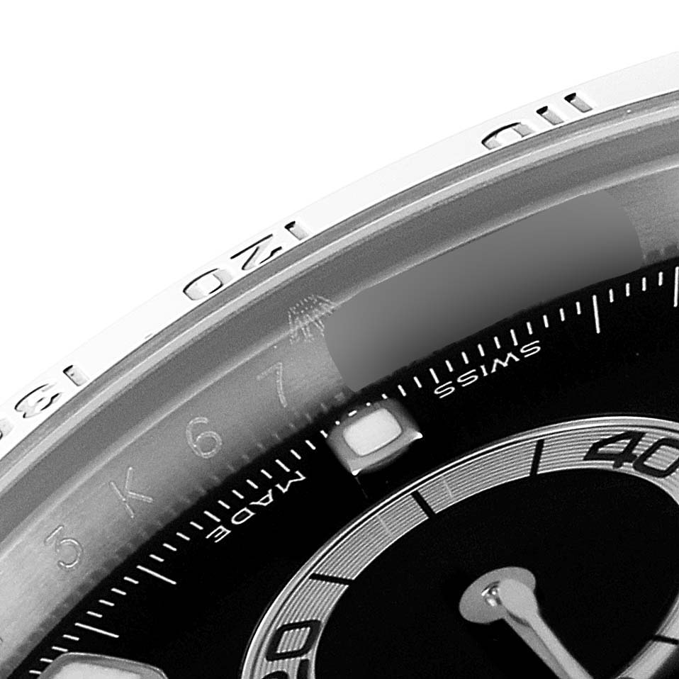 This image shows a close-up of the bezel and part of the dial of a Rolex Daytona 116520 Men
s Stainless Steel Black Dial 116520 Men
s Stainless Steel Black Dial watch.