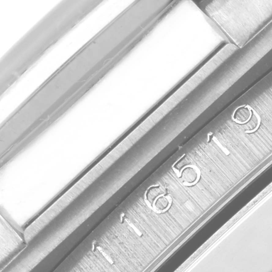 The close-up image shows a partial view of the bezel and serial number of a Rolex Daytona 116519 Men's White Gold Silver Dial 116519 Men's White Gold Silver Dial watch.