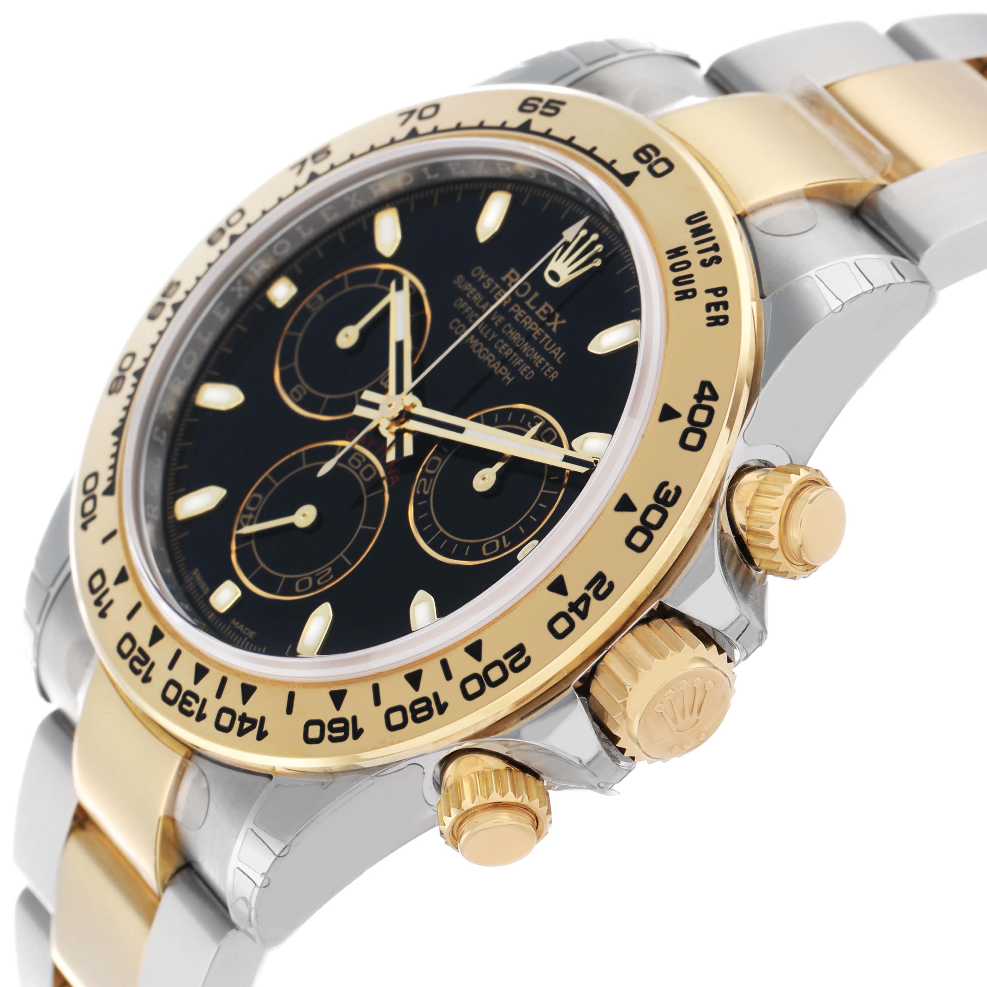 The Rolex Daytona 116503 Men
s Steel and Gold (two tone) Black Dial watch is shown at an angle highlighting the bezel, crown, pushers, and part of the bracelet.