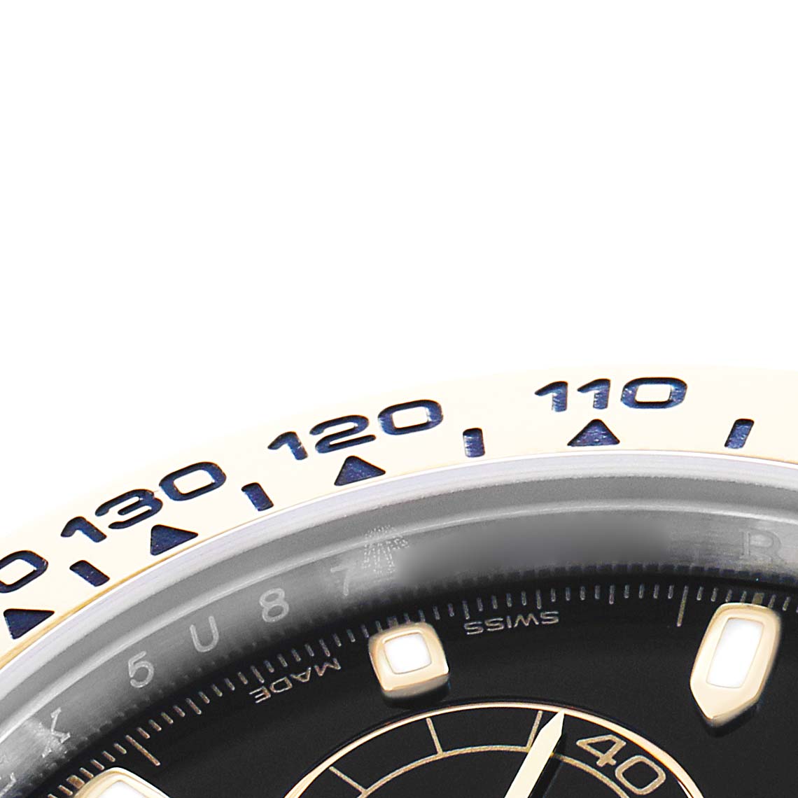 The image shows a close-up of the Rolex Daytona 116503 Men
s Steel and Gold (two tone) Black Dial
s bezel and part of the dial with indices and markings.