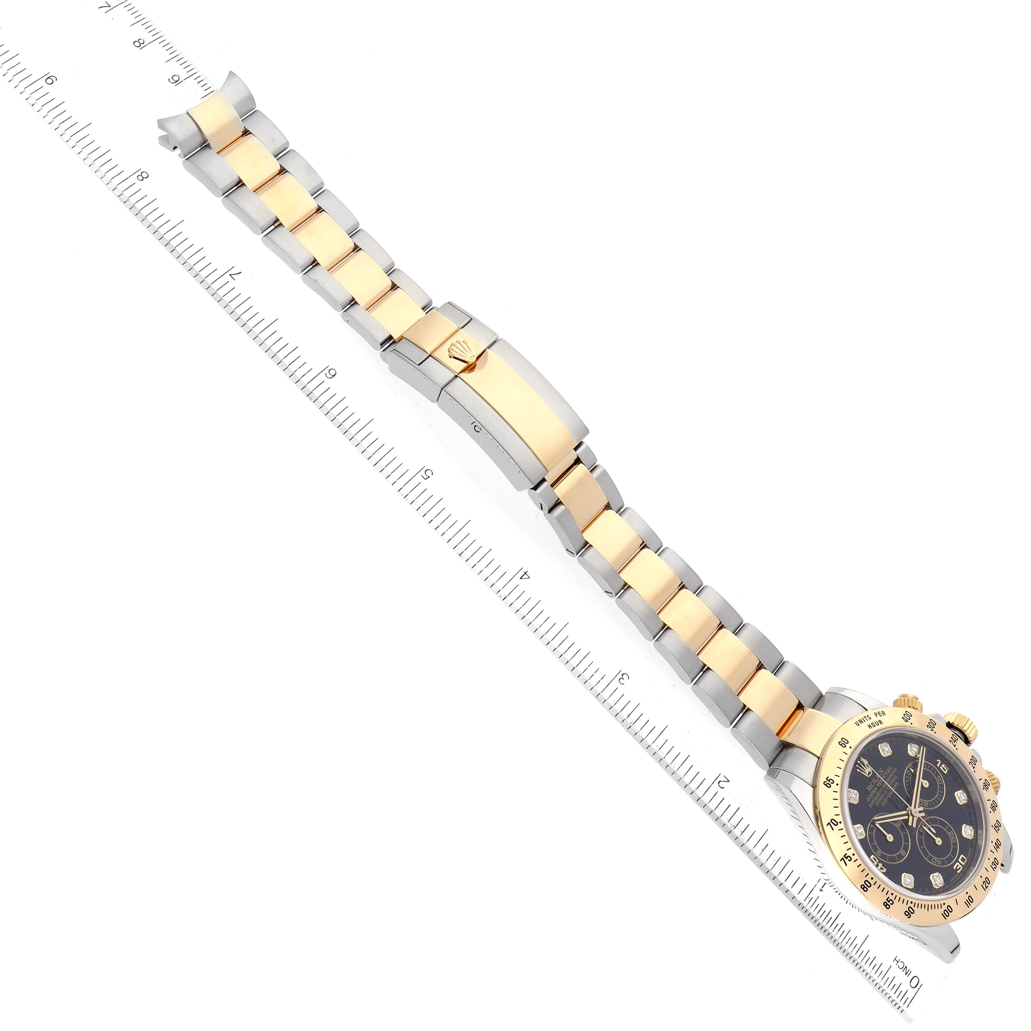 The image shows a top-down view of a Rolex Daytona 116523 Men
s Steel and Gold (two tone) Black Dial 116523 Men
s Steel and Gold (two tone) Black Dial watch, highlighting its gold and silver strap and the face with its bezel and dial.