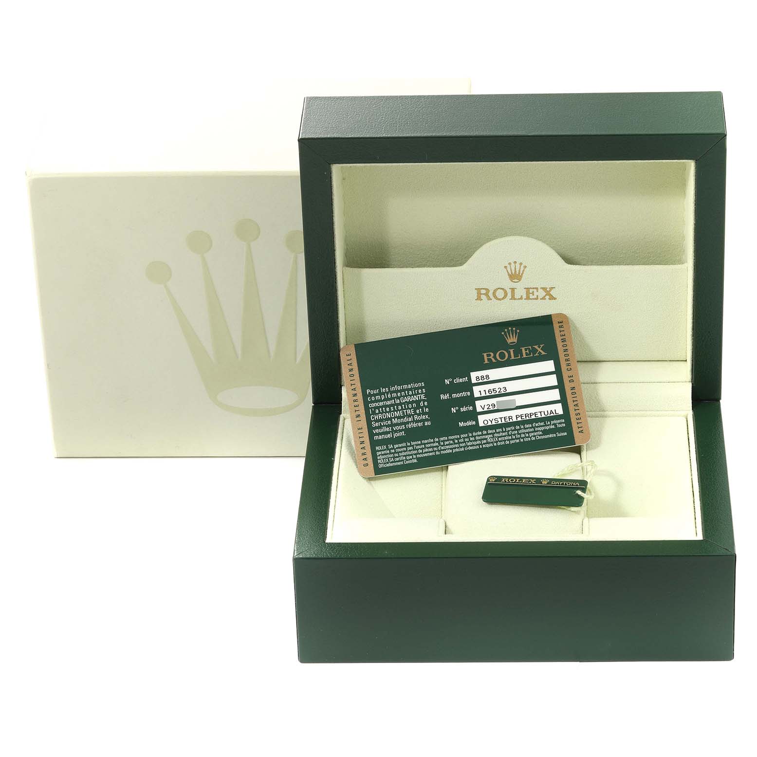 The image shows a Rolex Daytona 116523 Men
s Steel and Gold (two tone) Black Dial 116523 Men
s Steel and Gold (two tone) Black Dial watch box at an angle, along with its guarantee card and accessories.