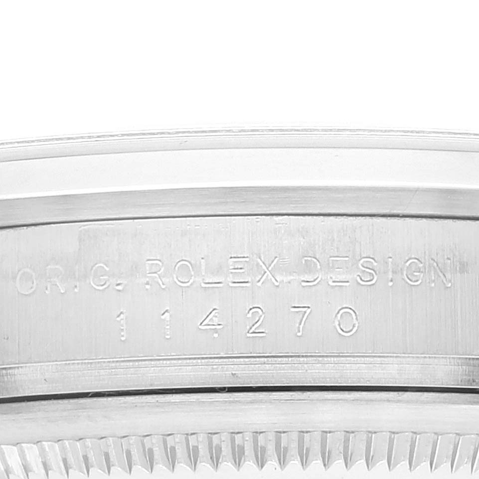 The image shows a close-up of the case side of a Rolex Explorer 114270 Men's Stainless Steel Black Dial 114270 Men's Stainless Steel Black Dial watch, highlighting the engraved model number 114270.