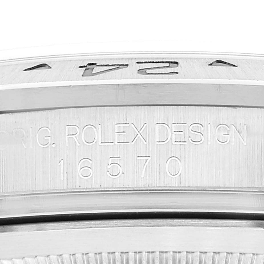 This is a close-up of the side engraving on the bezel and case of a Rolex Explorer 16570 Men's Stainless Steel White Dial 16570 Men's Stainless Steel White Dial model 16570.