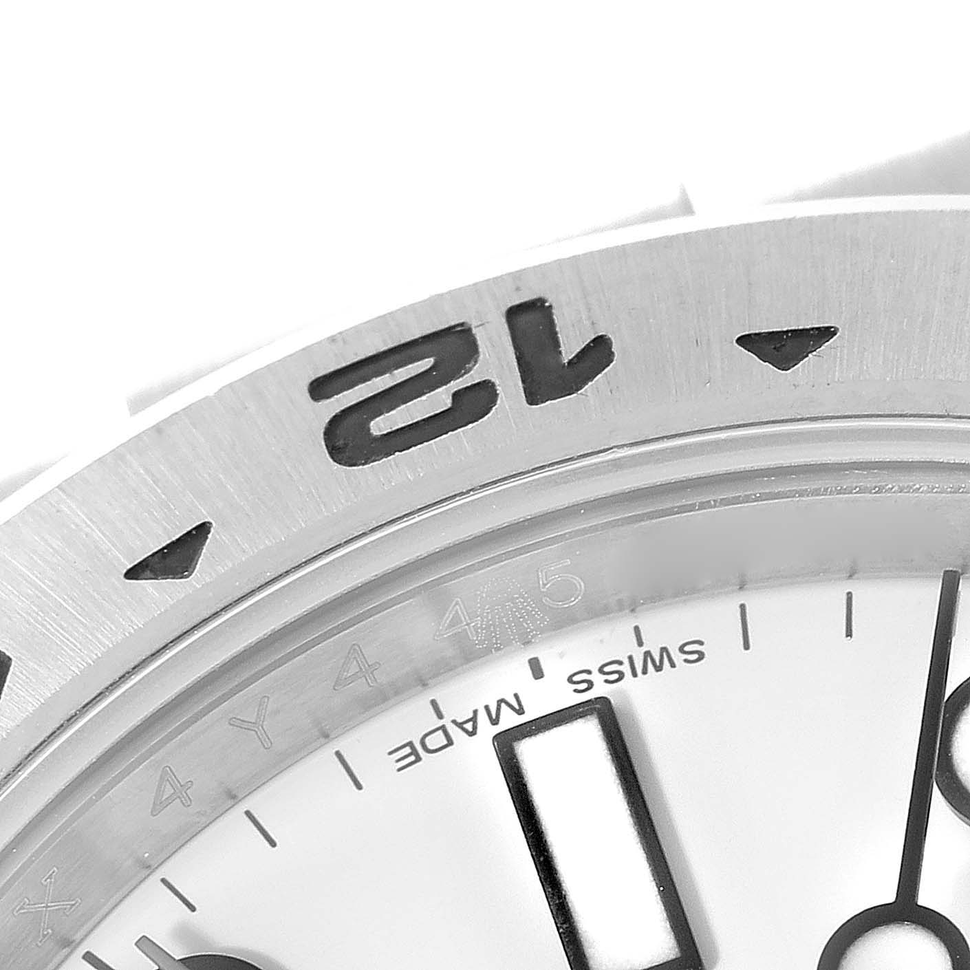 A close-up of the 12 o
clock position on the bezel and dial of the Rolex Explorer 216570 Men
s Stainless Steel White Dial 216570 Men
s Stainless Steel White Dial watch, showing the "Swiss Made" text.