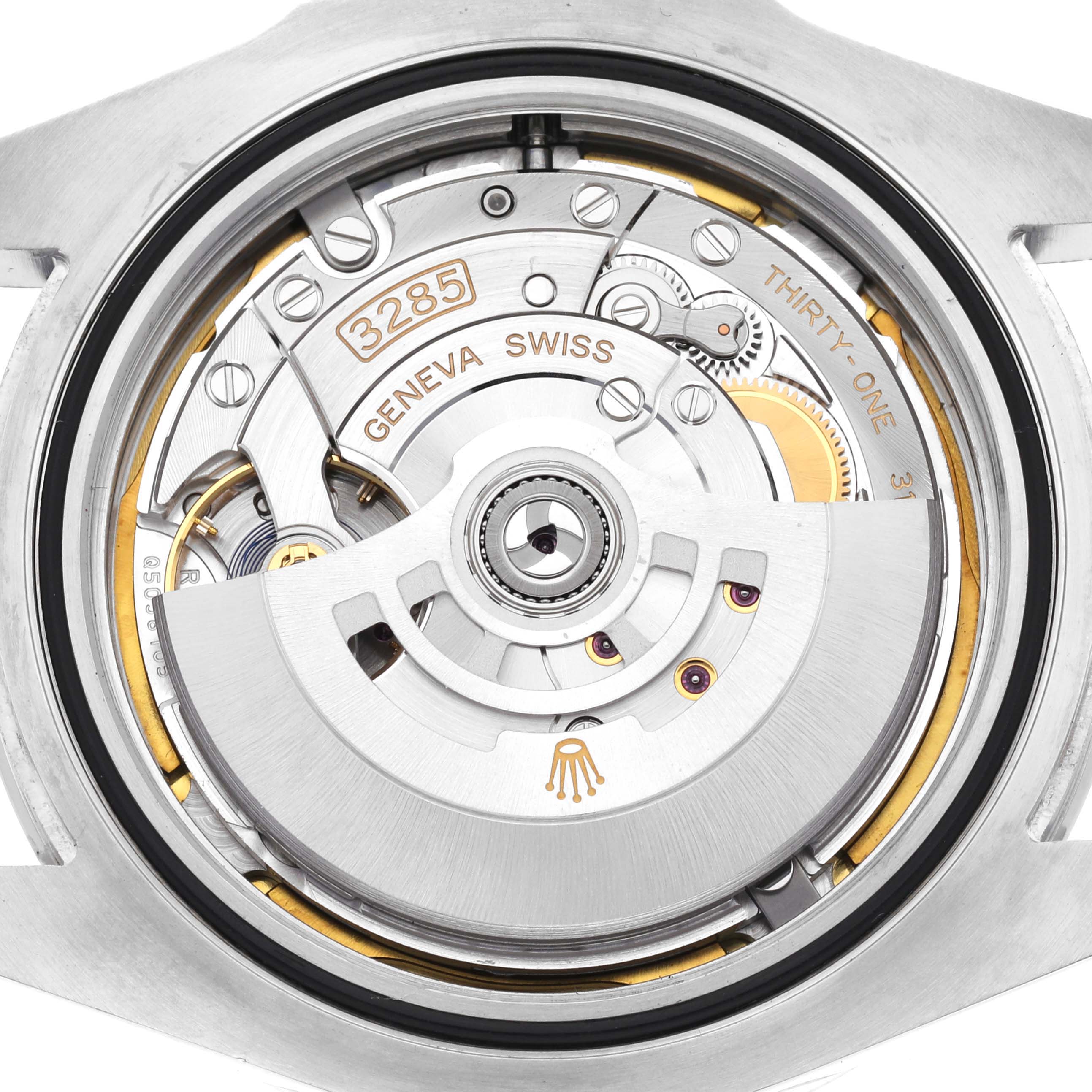 The image shows the movement components of a Rolex Explorer 226570 Men's Stainless Steel White Dial 226570 Men's Stainless Steel White Dial watch from the back, revealing intricate gears and the rotor.