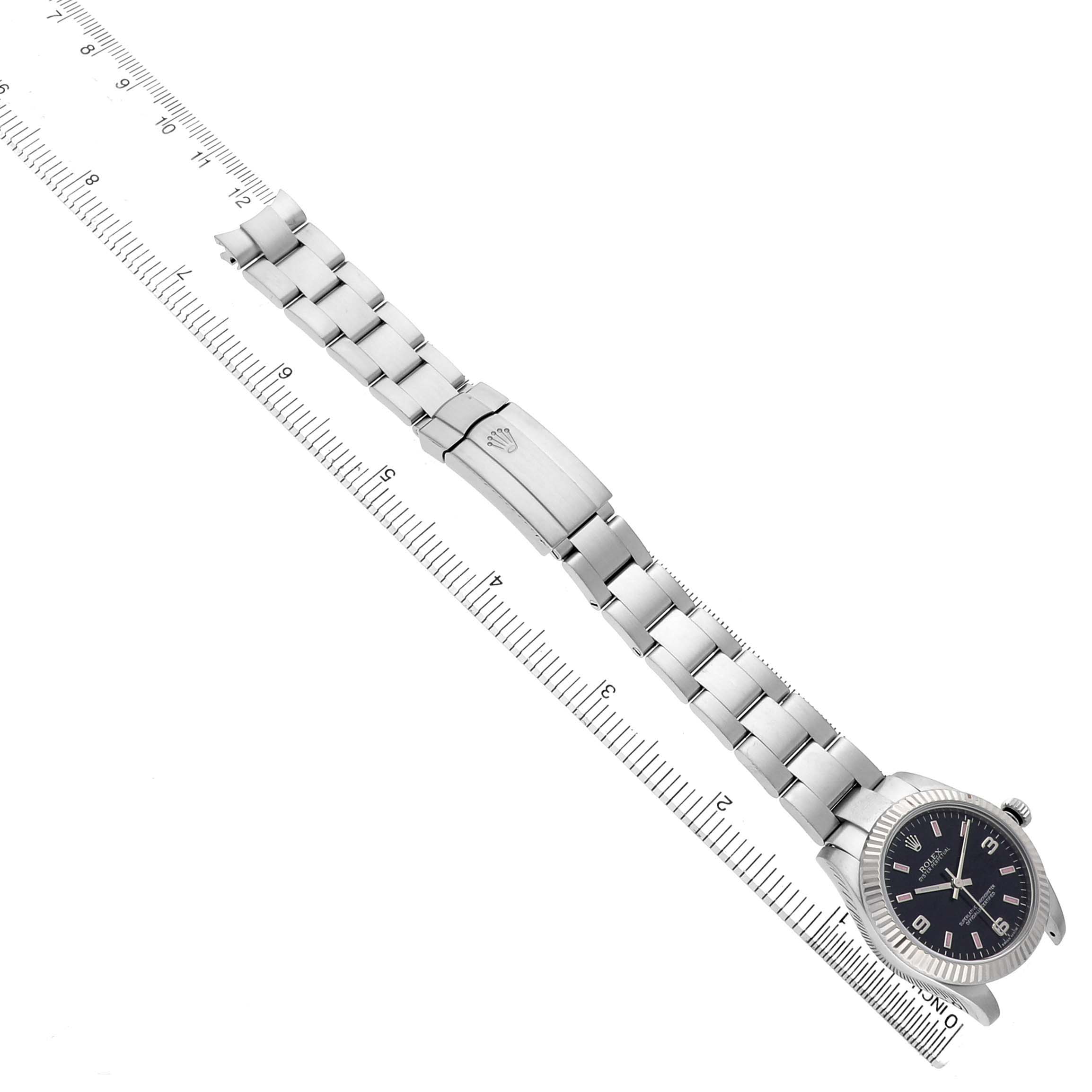 The Rolex Oyster Perpetual 177234 Women's Stainless Steel Black Dial watch is shown at a diagonal angle, displaying the bracelet, clasp, and dial face.