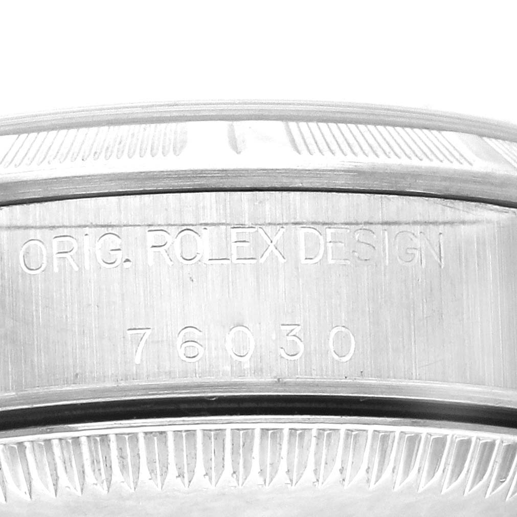 This close-up image shows the side engraving on the bezel of a Rolex Oyster Perpetual 76030 Women's Stainless Steel Black Dial 76030 Women's Stainless Steel Black Dial model.