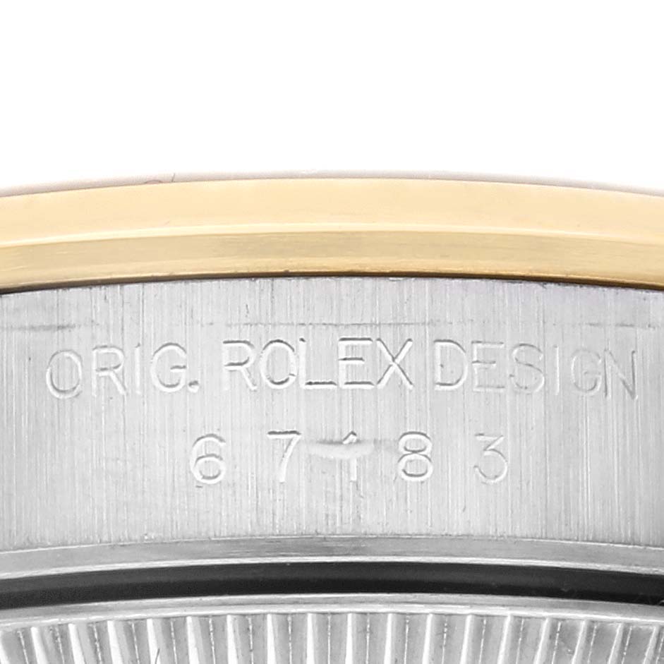 This is a close-up angle showing the bezel and engraved model number of the Rolex Oyster Perpetual 67183 Women's Steel and Gold (two tone) Grey Dial 67183 Women's Steel and Gold (two tone) Grey Dial watch.