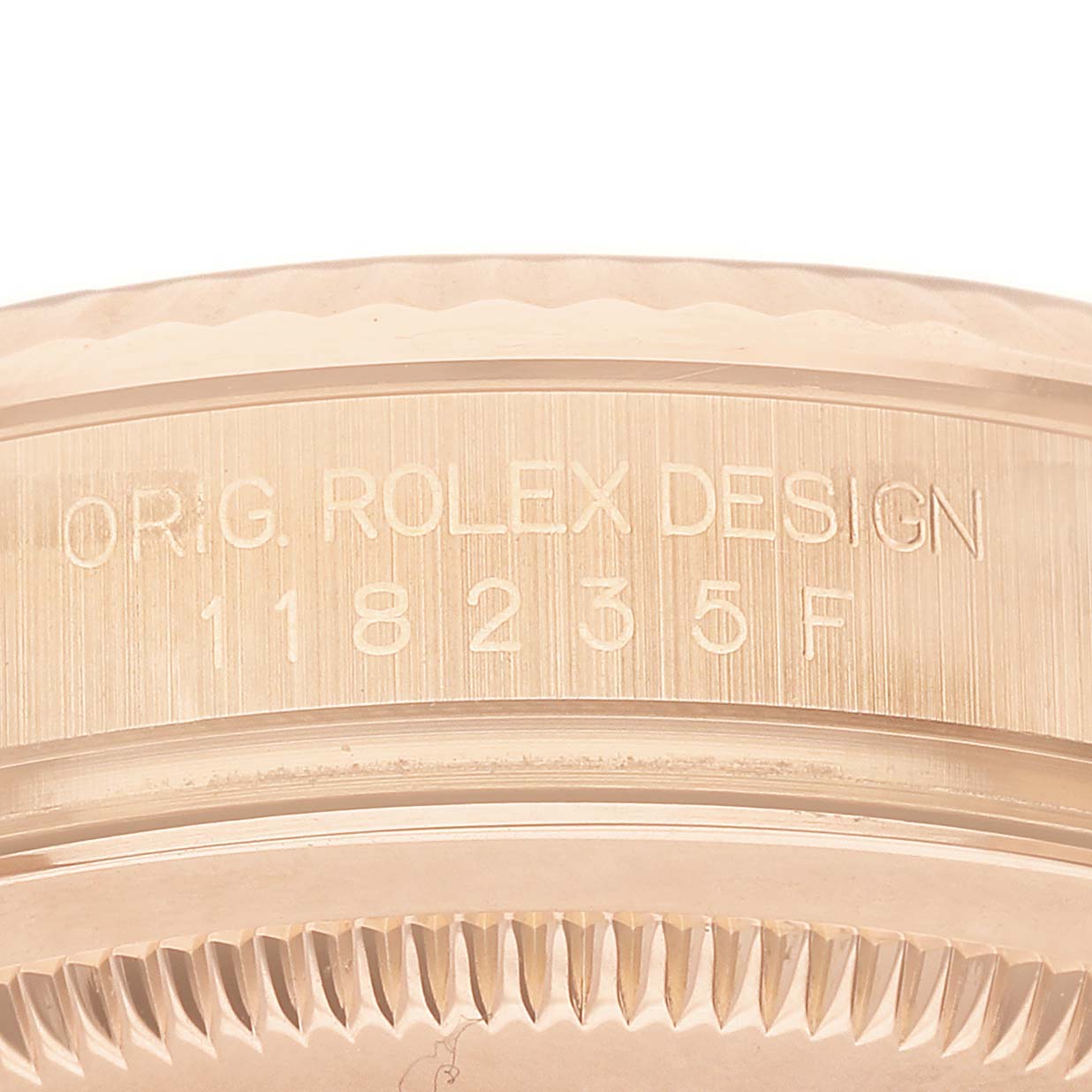 The image shows a close-up of the side of a Rolex President 118235 Men's Rose Gold Pink Dial model, focusing on the engraved design and model number.